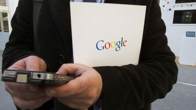 Hombre buscando en el móvil con carpeta de google
