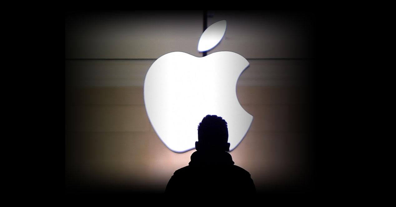 Logotipo de apple sobre fondo negro con persona delante