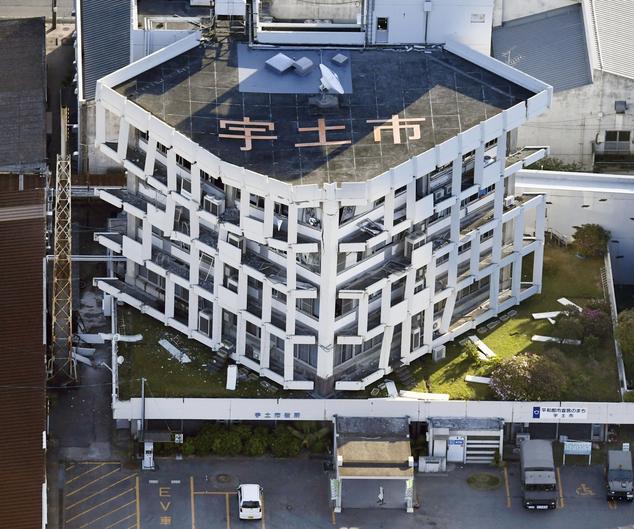 Exterior wall of the city hall fall off after the earthquake in Uto, Kumamoto prefecture, southern Japan Saturday, April 16, 2016. A powerful earthquake struck southern Japan early Saturday, barely 24 hours after a smaller quake hit the same region. (Muneyuki Tomari/Kyodo News via AP) JAPAN OUT, MANDATORY CREDIT