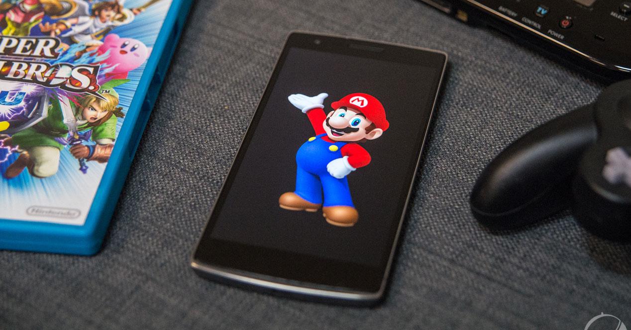 Juego de Wii y smartphone con Super Mario en pantalla