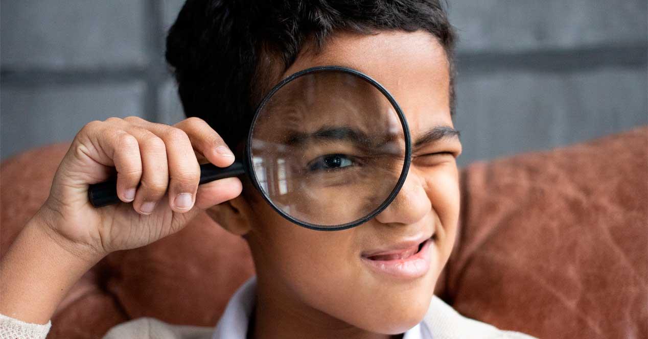child with magnifying glass