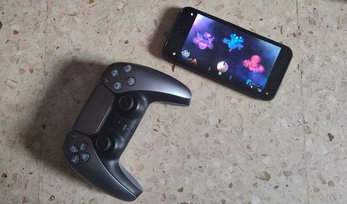 móvil con juego Astro Bot y mando ps5