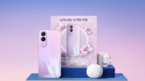 Teléfono Vivo V70 FE 5G en color violeta junto a su caja, cargador de pared y estuche de auriculares inalámbricos.
