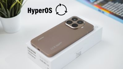 Parte trasera de un Xiaomi 15T Pro en color dorado sobre su caja blanca, junto al logotipo de HyperOS y un icono de actualización.