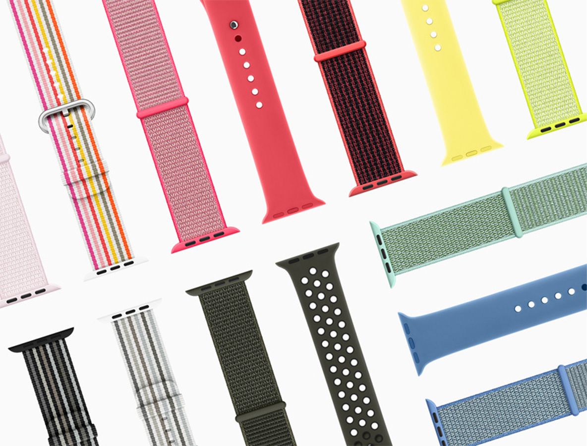 Variedad de correas para Apple Watch en diferentes colores y materiales dispuestas sobre fondo blanco.