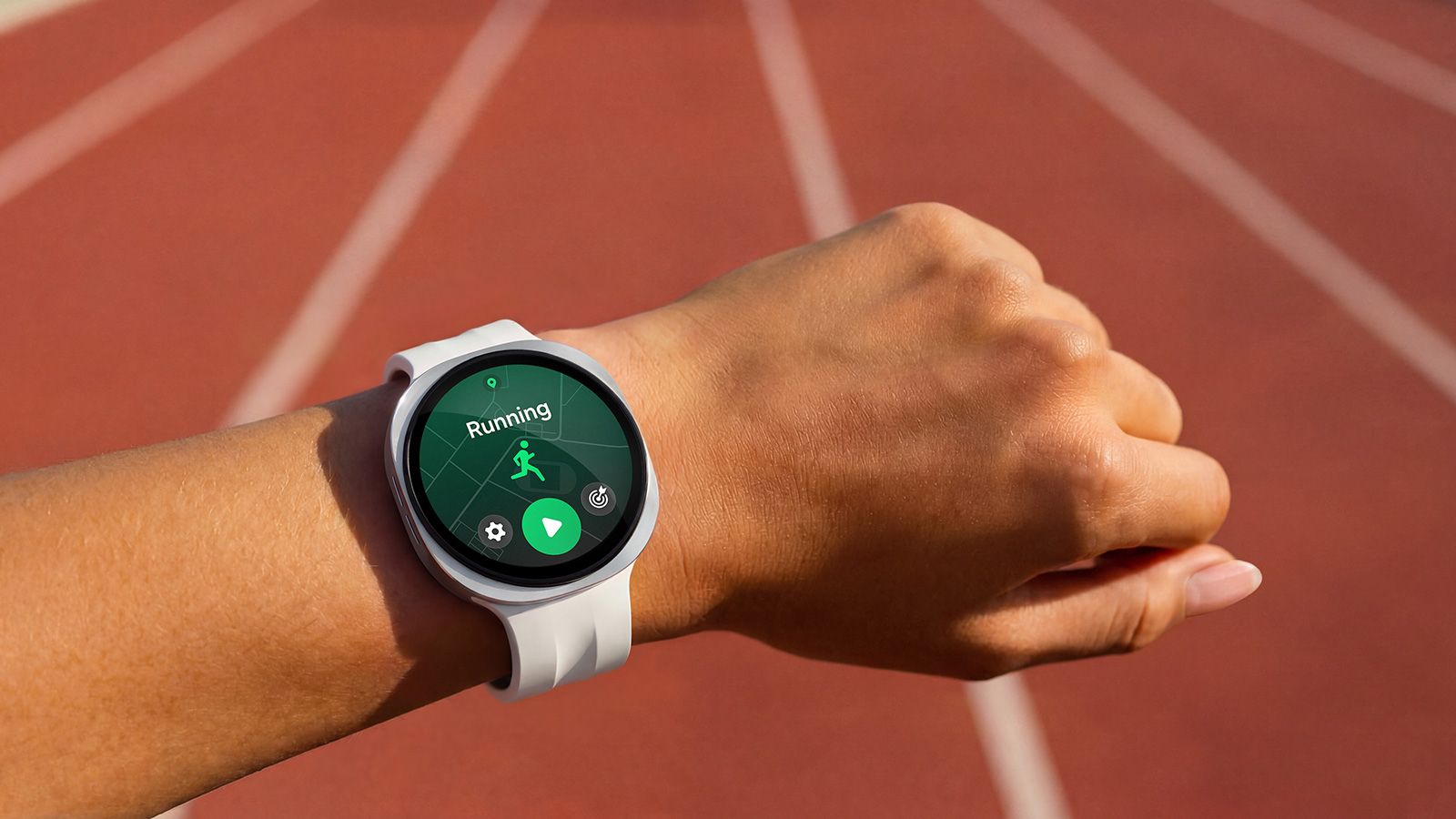 Reloj inteligente Samsung Galaxy Watch Ultra 2 con interfaz de carrera en una pista de atletismo.